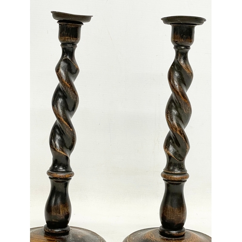 160 - A pair of tall early 20th century Barley Twist oak candlesticks. 1900-1910. 13.5x32cm.