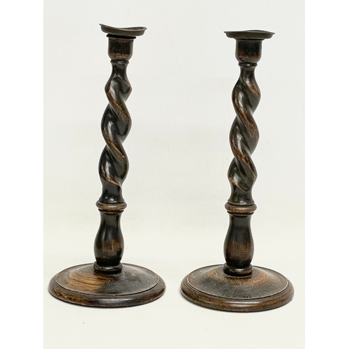 160 - A pair of tall early 20th century Barley Twist oak candlesticks. 1900-1910. 13.5x32cm.