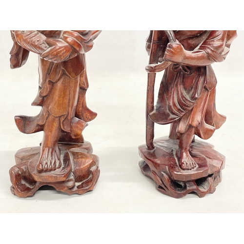 168 - A pair of vintage Chinese teak fisherman figures. 21cm.