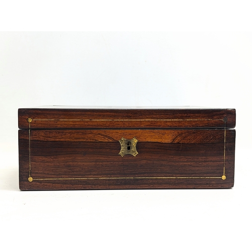 105 - A Victorian rosewood brass inlaid writing slope. 30.5x23.5x11.5cm