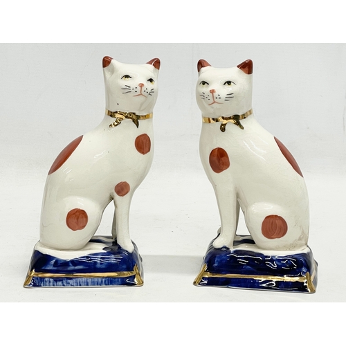 174 - A pair of Staffordshire Ware pottery cats. 18.5cm