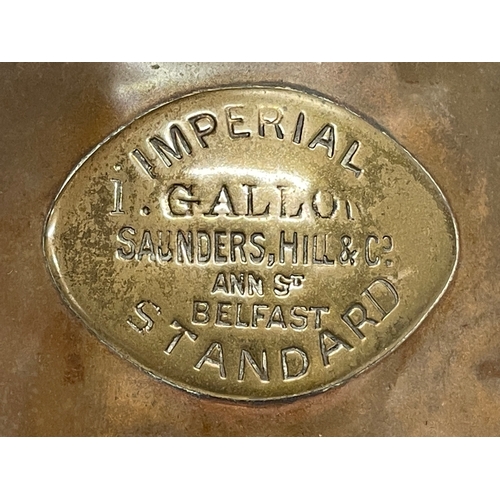 296 - A large Victorian copper jug. Saunders, Hill & Co, Belfast. 25x29cm