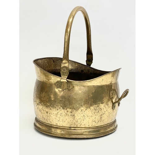 116 - An early 20th century brass coal scuttle. 33x30x40cm including handle.