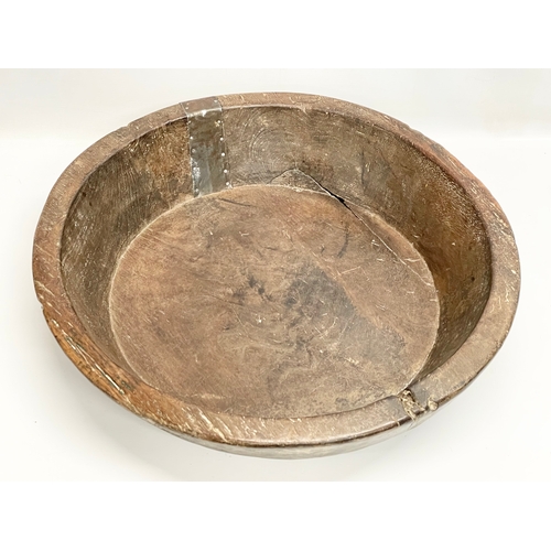 59 - A large late 19th/early 20th century Indian food preparation bowl. 53x54x11cm