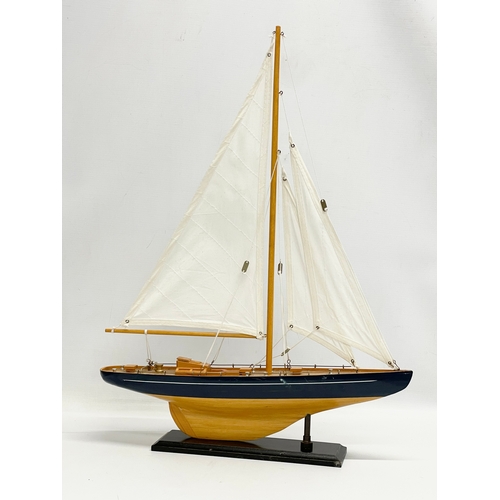 176 - A wooden model yacht. 42x55.5cm