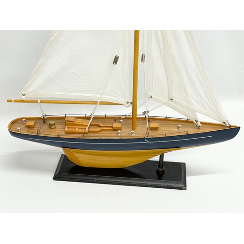 176 - A wooden model yacht. 42x55.5cm