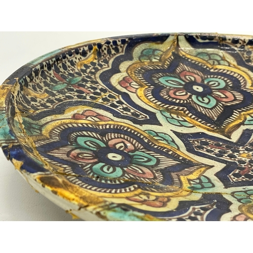 178 - A large 19th century Moroccan stoneware pottery bowl. 28.5x5.5cm