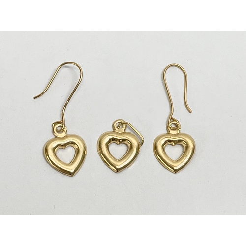 542 - 18ct gold earrings and matching pendant.