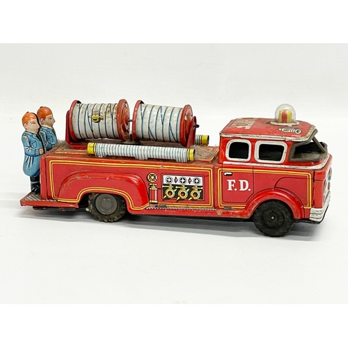 221 - A vintage tin plate fire truck. 23cm