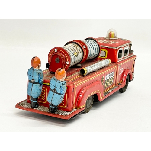 221 - A vintage tin plate fire truck. 23cm