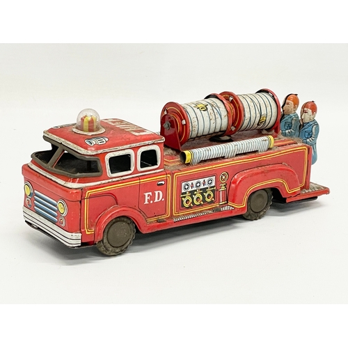 221 - A vintage tin plate fire truck. 23cm