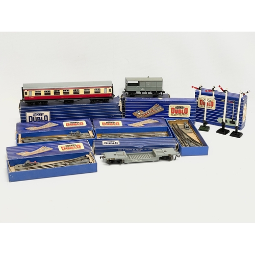 226 - A collection of vintage Hornby Dublo train carriages and tracks etc in boxes.