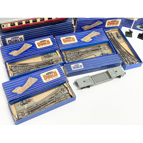 226 - A collection of vintage Hornby Dublo train carriages and tracks etc in boxes.