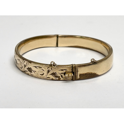 553 - A rolled gold bangle.