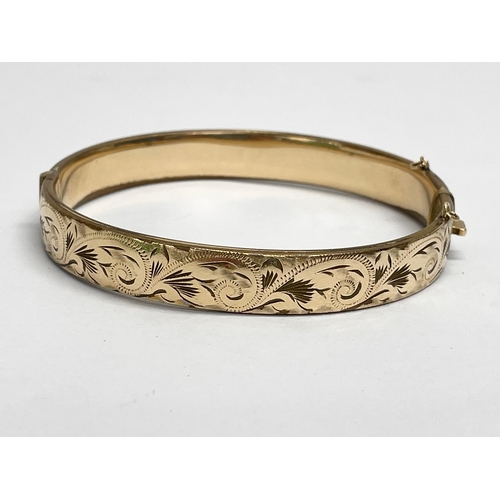 553 - A rolled gold bangle.