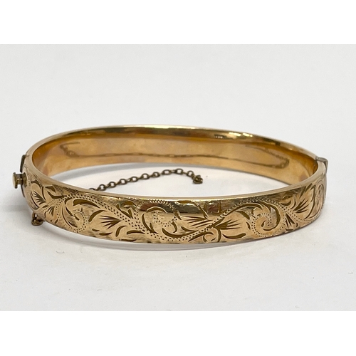 557 - A rolled gold bangle.