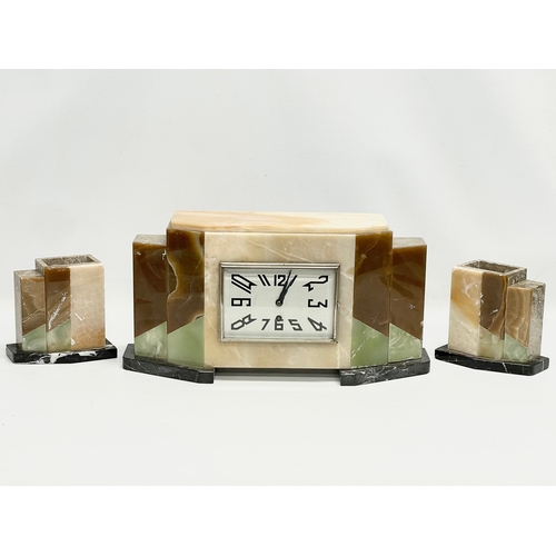 121 - A 1930’ Art Deco slate clock set by Marti Jours. Clock measures 42x11x21cm. Garnitures measure 14x8x... 