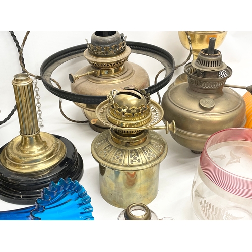 60 - A quantity of 19th and early 20th century oil lamps, shades oil lamp parts.