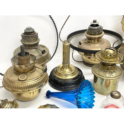 60 - A quantity of 19th and early 20th century oil lamps, shades oil lamp parts.