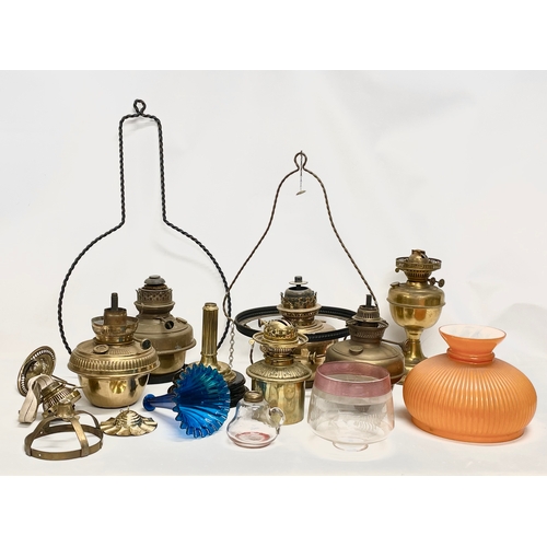 60 - A quantity of 19th and early 20th century oil lamps, shades oil lamp parts.