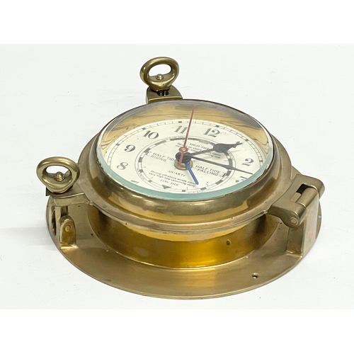 126 - A brass ships clock. 19cm