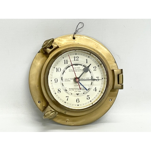 126 - A brass ships clock. 19cm