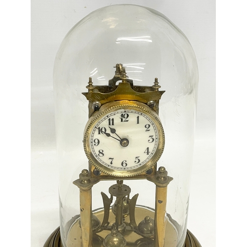 186 - An early 20th century brass Anniversary clock with glass dome. 32cm