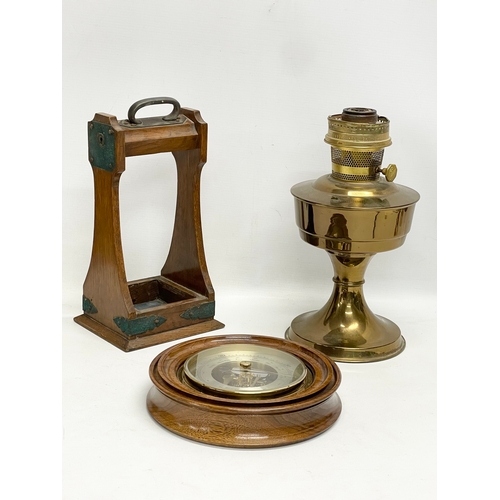 353 - A sundry lot. Including an Edwardian oak tantalus. An Aladdin brass oil lamp and a barometer.