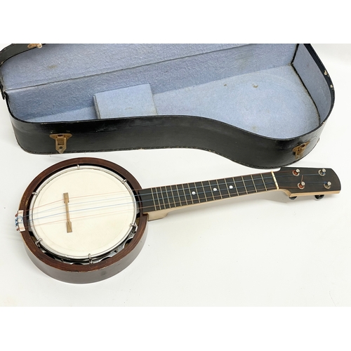 366 - A vintage Ukulele Banjo in case. 59cm