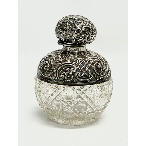 571 - A sterling silver perfume bottle. 8x10cm