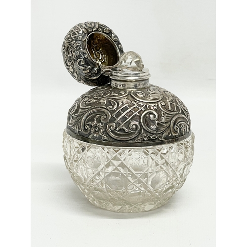 571 - A sterling silver perfume bottle. 8x10cm