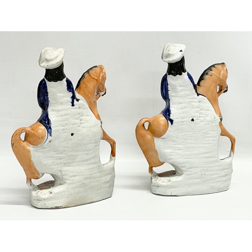 412 - A pair of 19th century Staffordshire pottery ‘Tom King’ figures. 18x25cm.