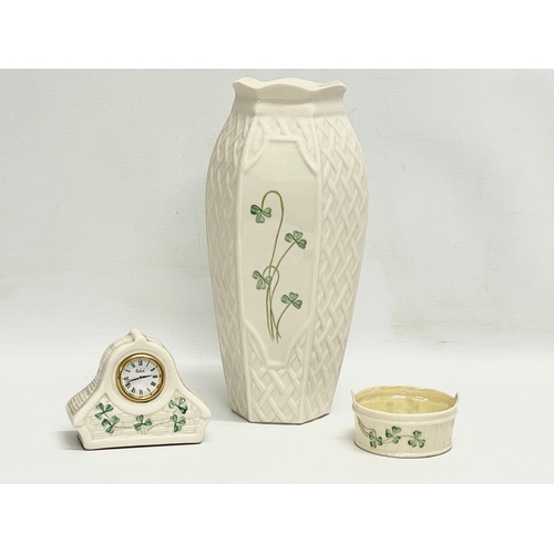 656 - 3 pieces of Belleek Pottery. Including a 3rd period butter bowl. Vase measures 26cm.