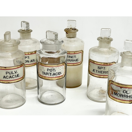 65 - 10 late 19th century chemist bottles. 20cm