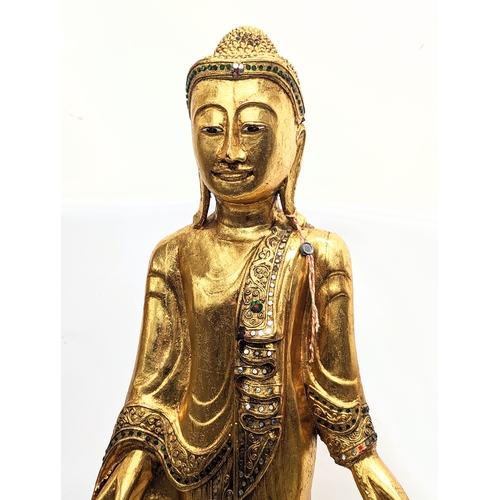 455 - A large gilded Burmese Buddha statue. 114cm