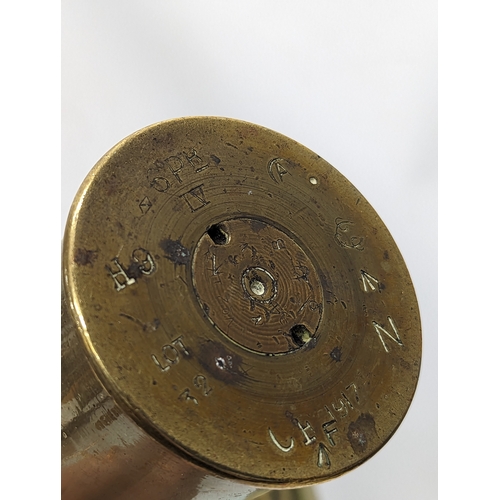 384 - A World War I brass Trench Art shell marked 1917, with World War II brass shell, marked 1942. Talles... 