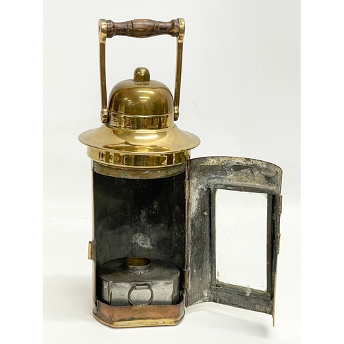 323 - A brass ships binnacle lamp. Stamped L.S Co LTD. 10x26cm including handle.