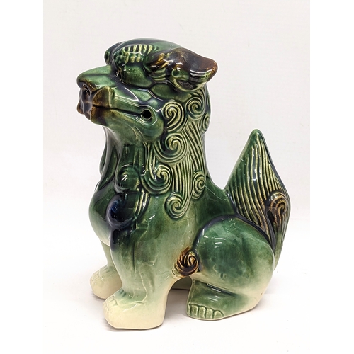 434 - A pair of Chinese pottery Foo Dogs. Largest measures 19.5cm