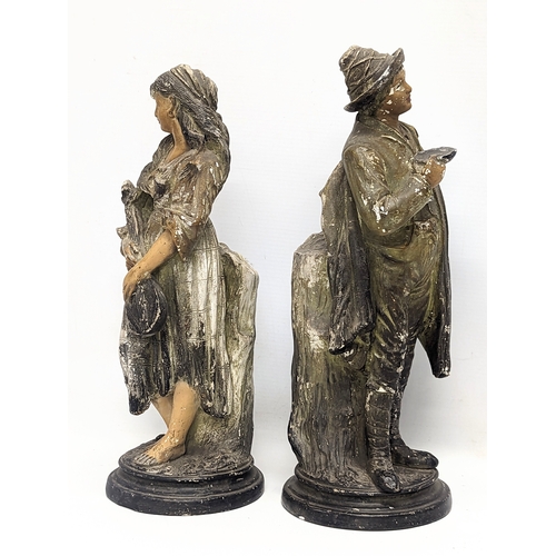 481 - A pair of early 20th century pottery figures. 34.5cm