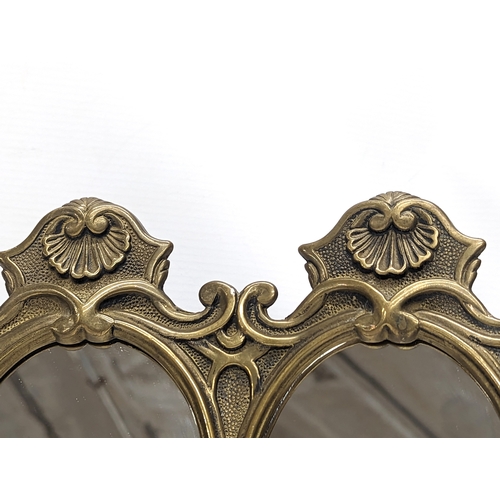 484 - A pair of ornate brass mirrors. 21x19.5cm