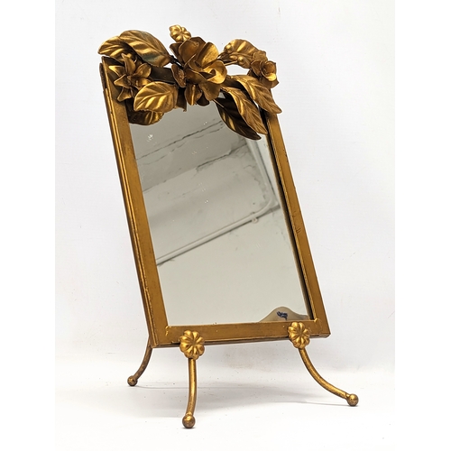 486 - An ornate gilt brass mirror. 22.5x38.5cm