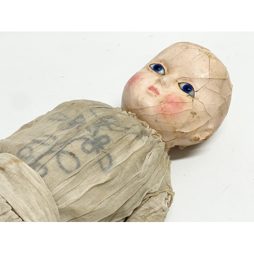 440 - A large late 19th/early 20th century doll with plaster face and arms. 59cm