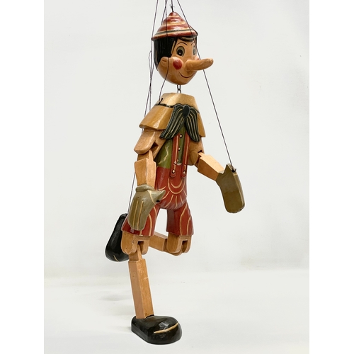 496 - A large vintage wooden Pinocchio puppet 65cm.