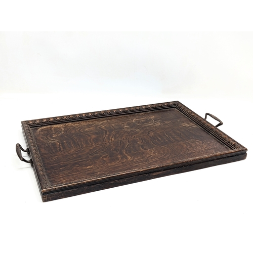 509 - An early 20th century oak serving tray. 57.5x36cm