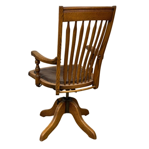 1015 - A late 19th century high back oak swivel desk chair. Dated from 1895.