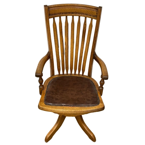 1015 - A late 19th century high back oak swivel desk chair. Dated from 1895.