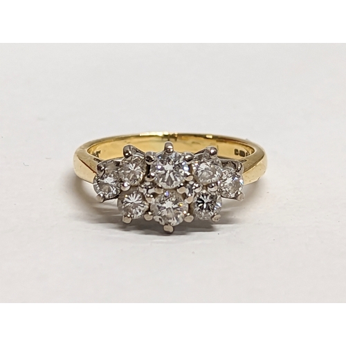 581 - An 18ct gold ring with 8 inset diamonds. 3.83g. Size UK J.