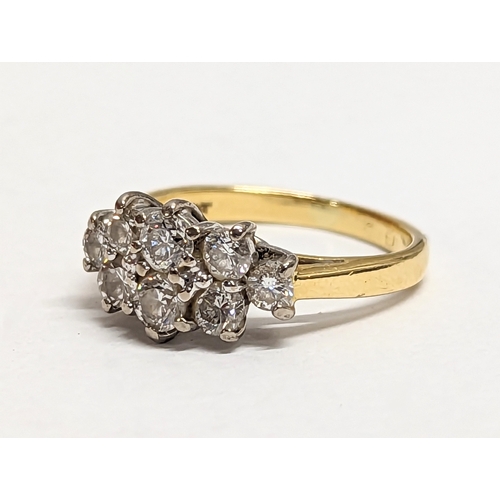 581 - An 18ct gold ring with 8 inset diamonds. 3.83g. Size UK J.