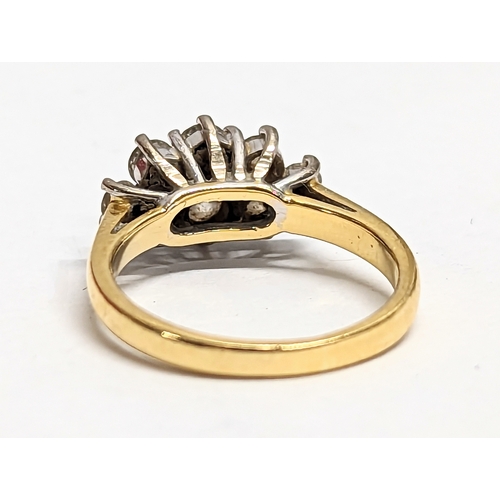 581 - An 18ct gold ring with 8 inset diamonds. 3.83g. Size UK J.