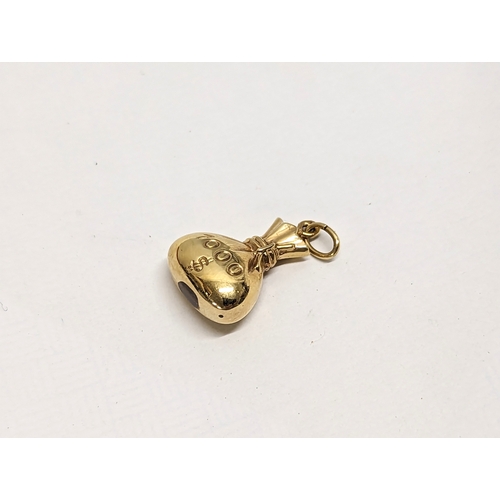 588 - A 14ct gold money bag charm